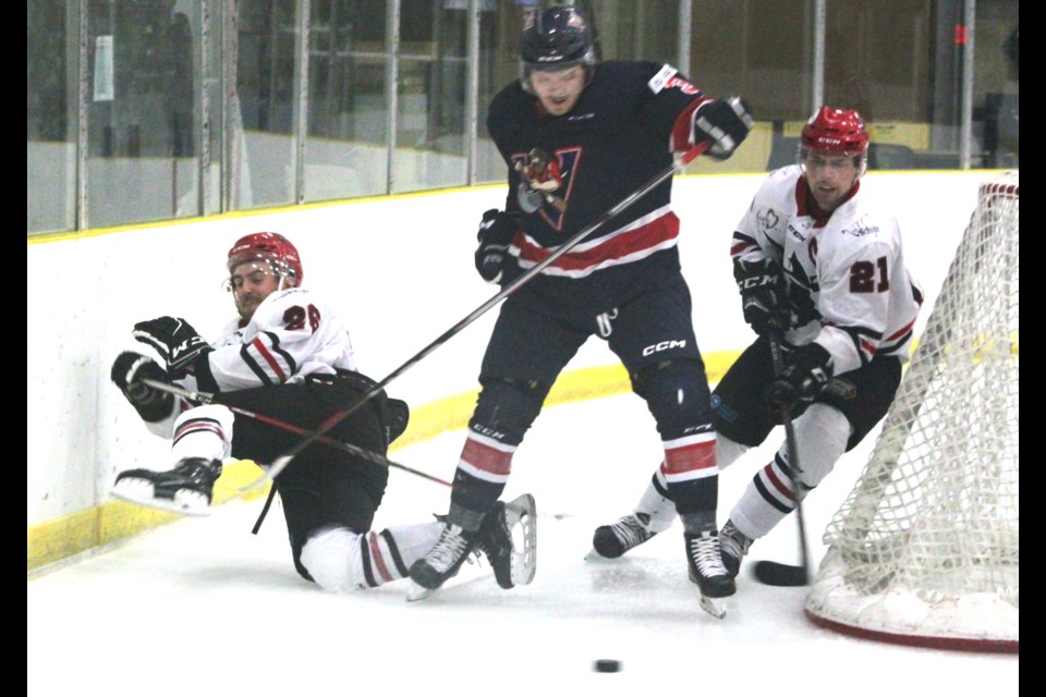 Out of my way: Portage College Voyageurs defenseman Thomas Colter is flanked by Owen Lamb and Tanner Manz of the University of Alberta Augustana Vikings as he races around the Voyageurs net during second period action of Friday’s exhibition game at the Bold Centre that saw the Voyageurs drop a 7-1 decision to the Vikings. Chris McGarry photo.