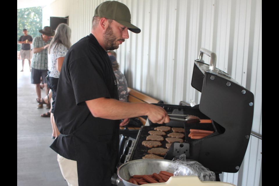 Warren Young was busy at the start of the 2025 edition of the Craigend Community Barbecue barbecuing hamburgers and hot dogs that were served at the event. Chris McGarry photo. 