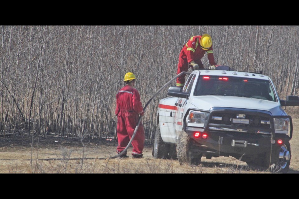 A Lac La Biche County Fire Rescue truck in front of a stretch of woods that had been charred by a grass fire that took place in Lac La Biche's Dumasfield neighbourhood on the afternoon of Saturday, April 30. Chris McGarry photo.