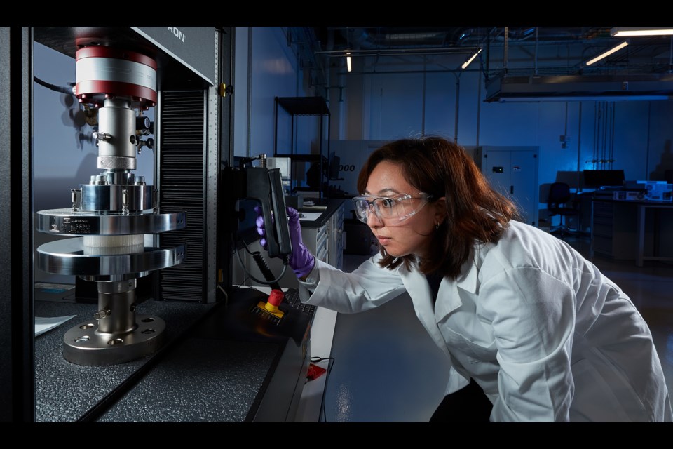 A Lawrence Livermore National Laboratory scientist uses an Instron Universal Testing Machine to perform a non-destructive evaluation.