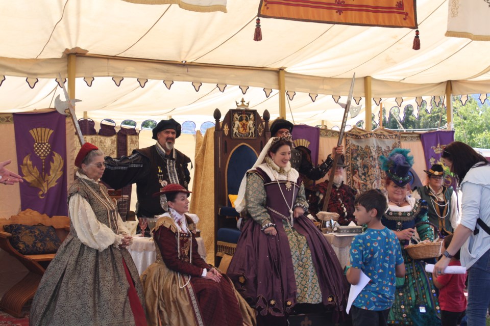"Queen Mary of Scotts" greets children at the Living History area of the festival. Performers gave live historical reenactments from medieval Scottish history and spoke with visitors.
