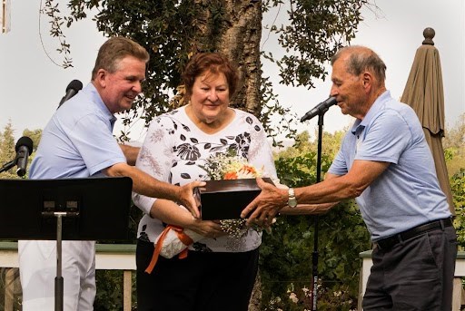 Keith Sawyer recognizes Jim and Bonnie Schmidt for their years of dedication at July's Opera in the Vineyard event at Retzlaff Vineyards. 