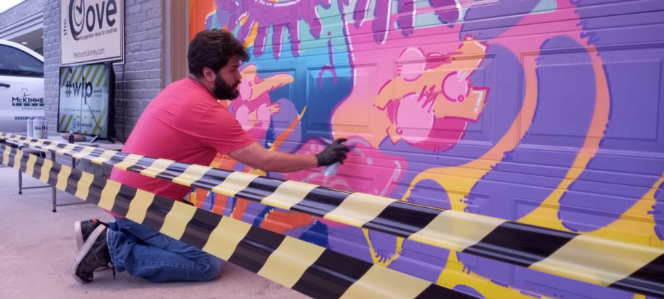 muralist-ivanevid-finishing-his-mural-outside-the-cove-photo-by-a-royer
