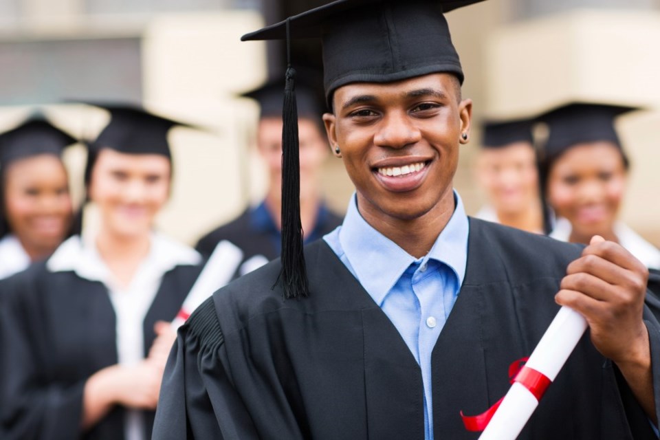 graduate multicultural boy diploma