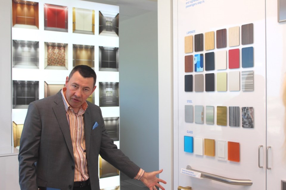 Patrick O'Connell, Director of Marketing at KONE, shows KONE elevator design choices.