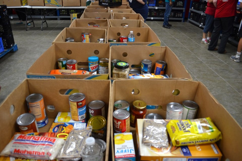 A line of boxes of food to be sorted at minnie's food pantry Plano non profit