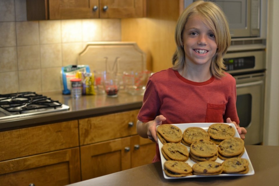 canaan-magness-9 boy showing cookies on a cookie sheet