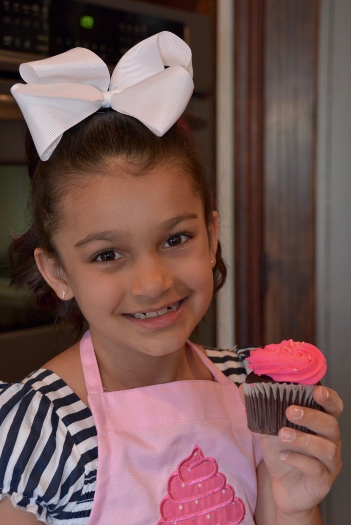 Sofina-chishti-7 child chef holding a cupcake