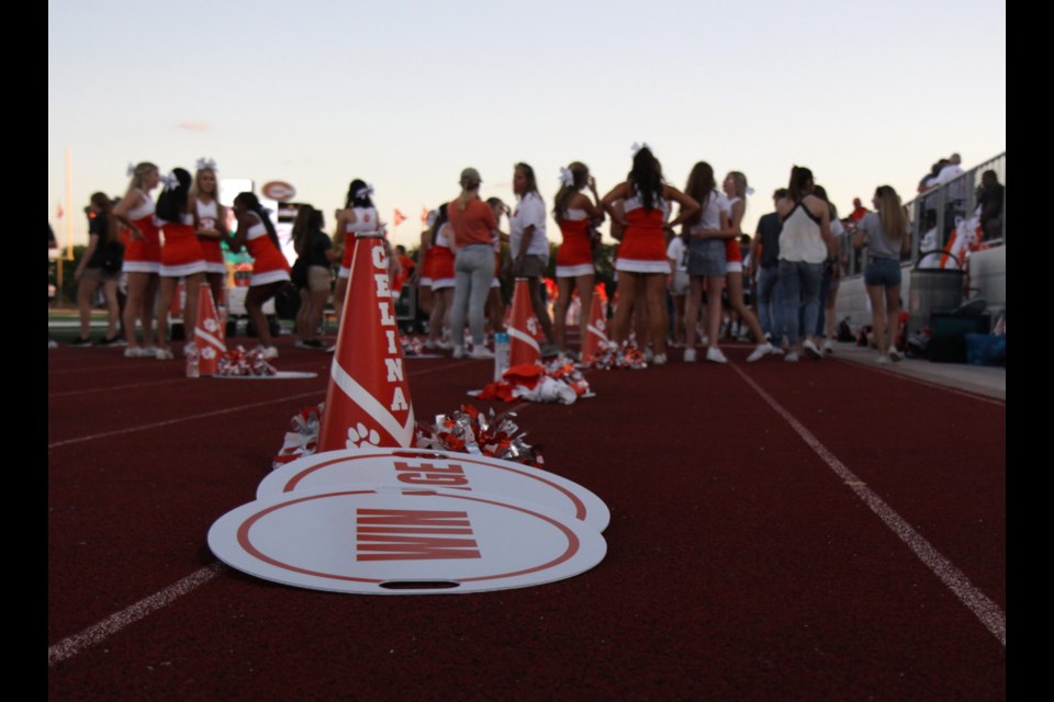 Celina High School cheerleaders mingle with bystanders before the varsity game against Sanger High School.