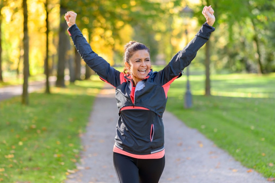 Happy fit woman cheering and celebrating