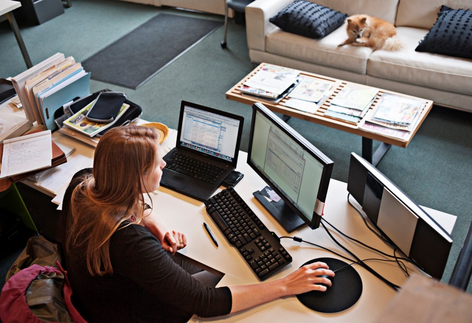 Overview of woman working at office computer