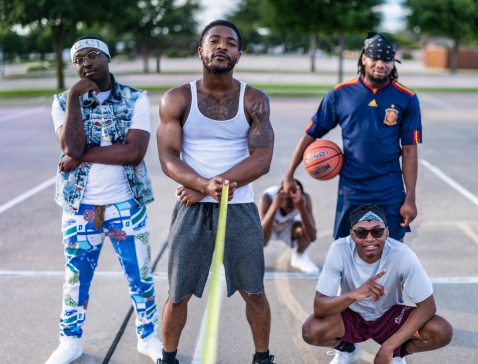 group of boys playing basketball six feet apart