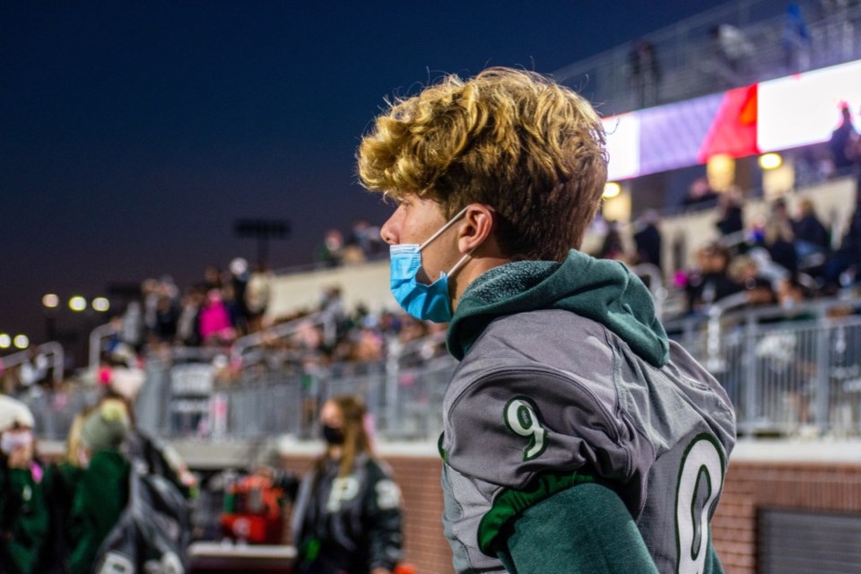 high school football player wearing a mask