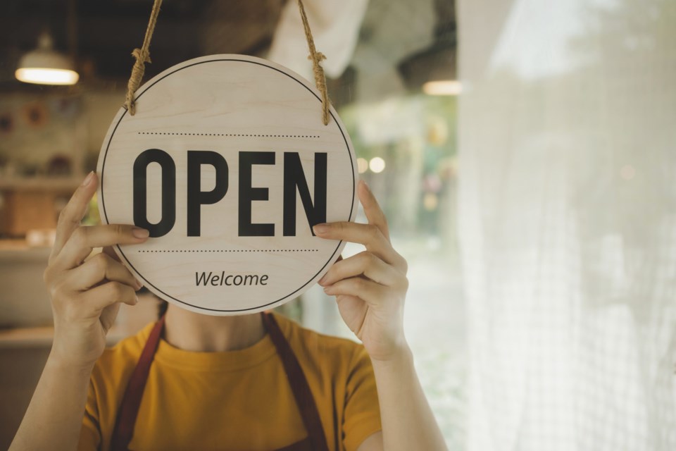 Reopen.,Waitress,Woman,Turning,Open,Sign,Board,Reopen,After,Coronavirus