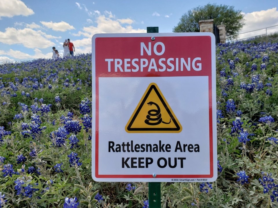 The new No Trespassing sign warns of rattlesnakes