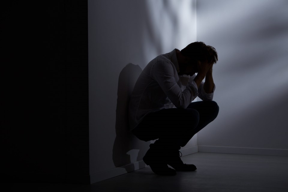 Abandoned,And,Lost,Man,Sitting,Beside,Wall,In,Dark,Room