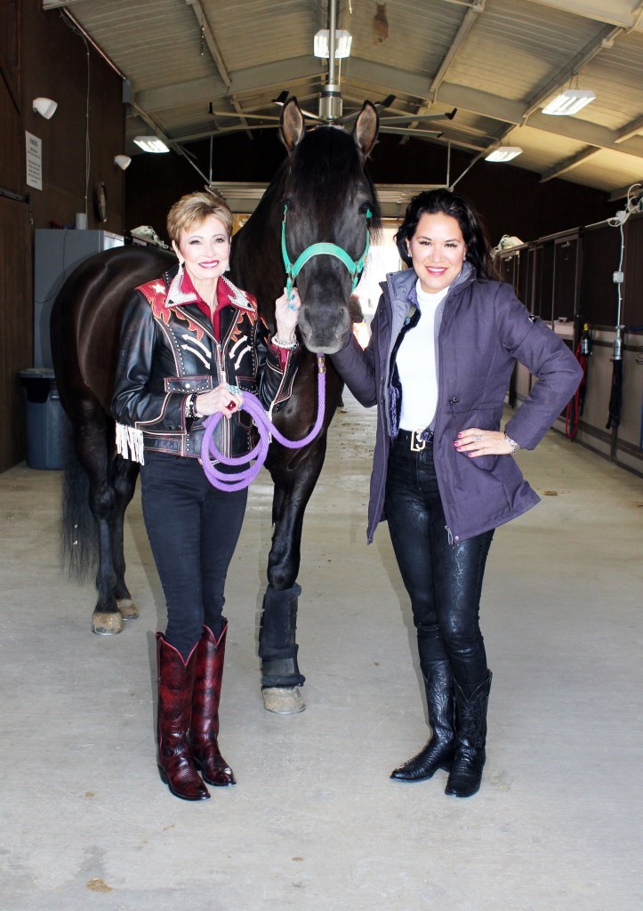 Kat Dozzo and Karla Vargas with Gitano, a rare pure black Carthusian horse.