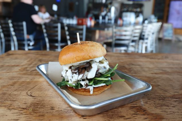 Grind Burger Bar y Taqueria has a great patio view, as you can see. Yum! | Courtesy of Grind Burger Bar y Taqueria's Instagram