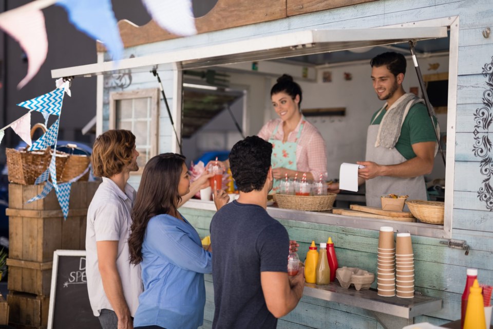 Smiling,Waiter,Taking,Order,From,Customer,At,Counter