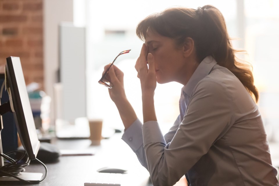 Exhausted,Female,Worker,Sit,At,Office,Desk,Take,Off,Glasses