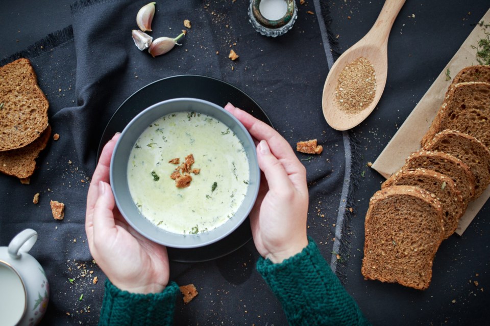 Female,Hands,In,A,Sweater,Hold,A,Plate,With,Soup