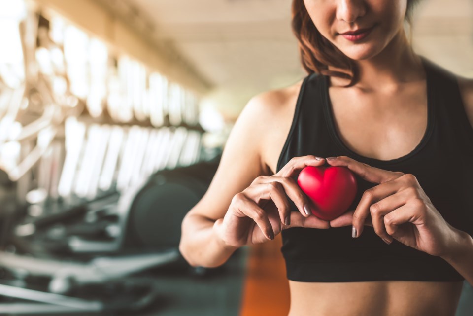 Happy,Sport,Woman,Holding,Red,Heart,In,Fitness,Gym,Club.