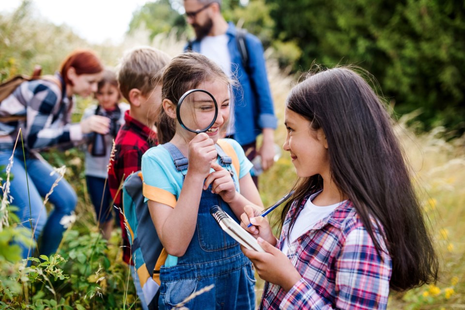 Group,Of,School,Children,With,Teacher,On,Field,Trip,In