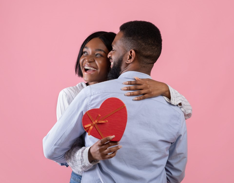 Excited,Black,Woman,Holding,Heart,Shaped,Gift,Box,And,Hugging