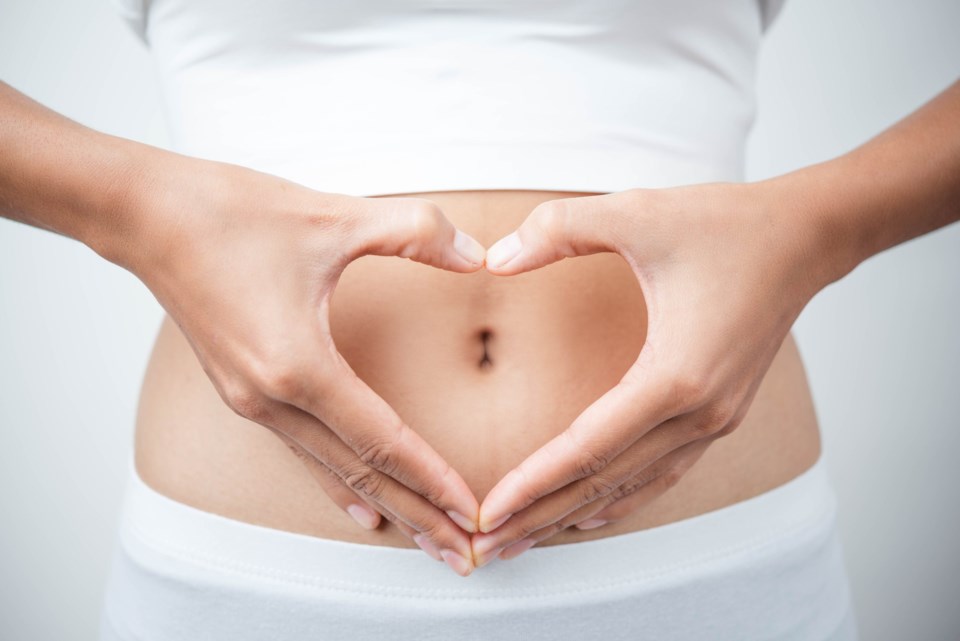 Close,Up,Of,Woman&#8217;s,Hands,Made,Heart,On,Belly,Isolated