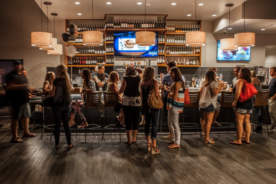 Pictured are customers at the bar at Pinstack.
