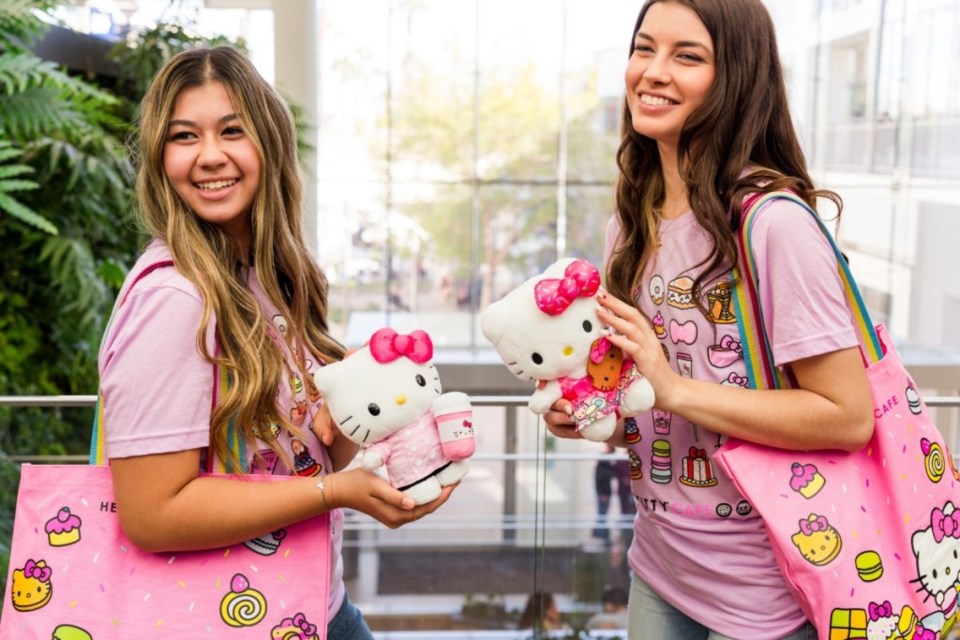 Two customers pose with Hello Kitty gear.