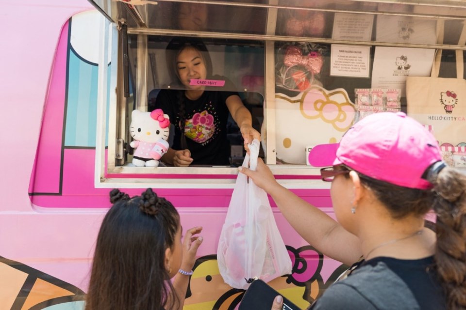 A customer receives her Hello Kitty merchandise after paying. 