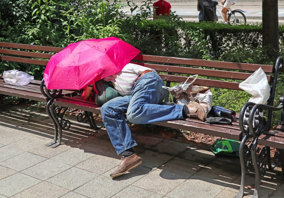 Homeless,Man,Is,Sleeping,On,A,Bench,In,The,City