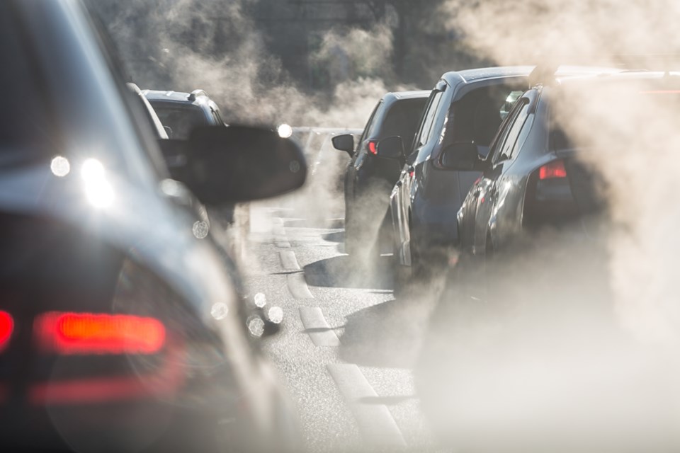 Blurred,Silhouettes,Of,Cars,Surrounded,By,Steam,From,The,Exhaust