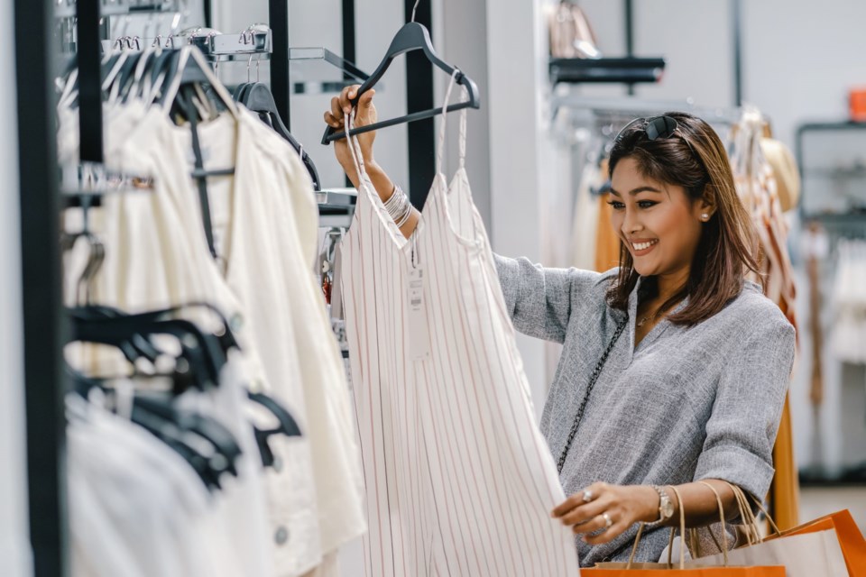 Happy,Asian,Woman,Choosing,Clothes,In,Shop,Store,With,Happy