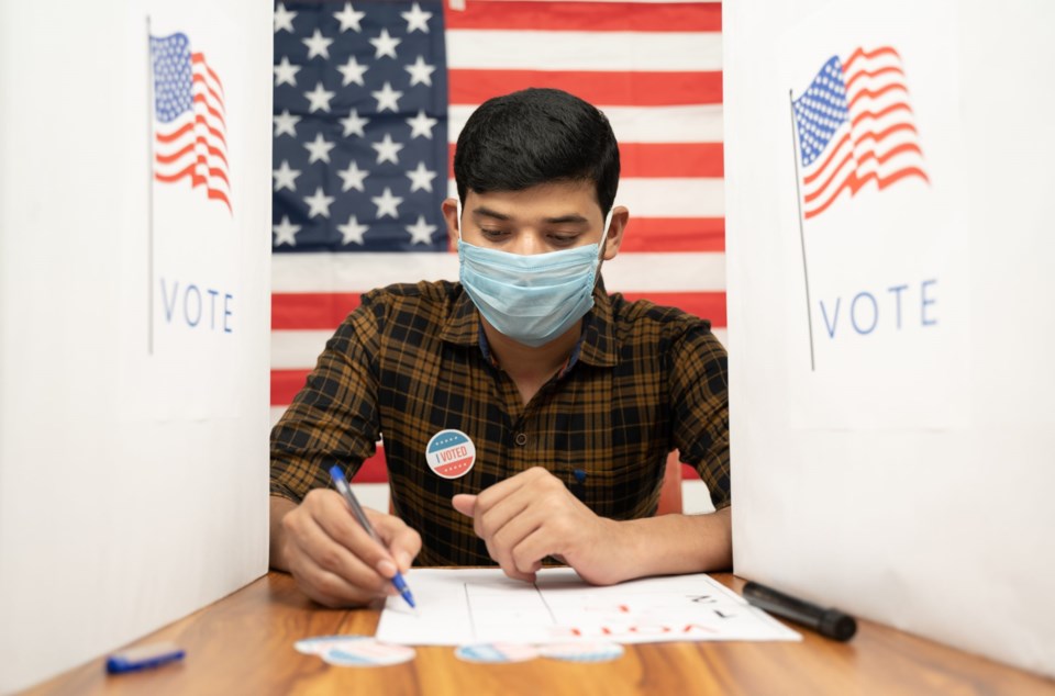 Young,Man,In,Medical,Mask,Busy,Inside,The,Polling,Booth