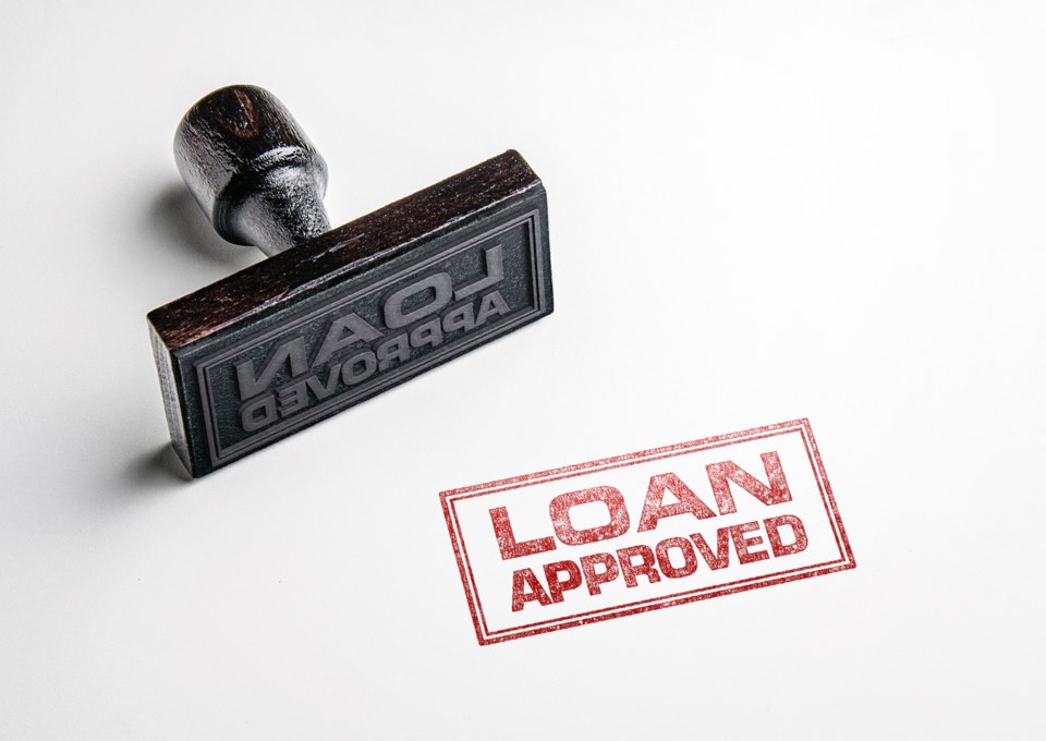 Rubber,Stamping,That,Says,&#8217;loan,Approved&#8217;.