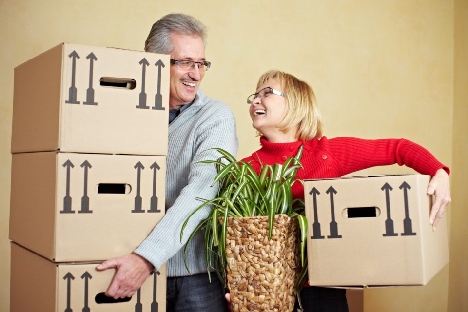 Two,Happy,Senior,People,With,Many,Moving,Boxes