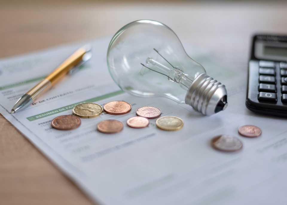 Electricity,Bill,With,Light,Bulb,,Several,Coins,,Calculator,And,Pen