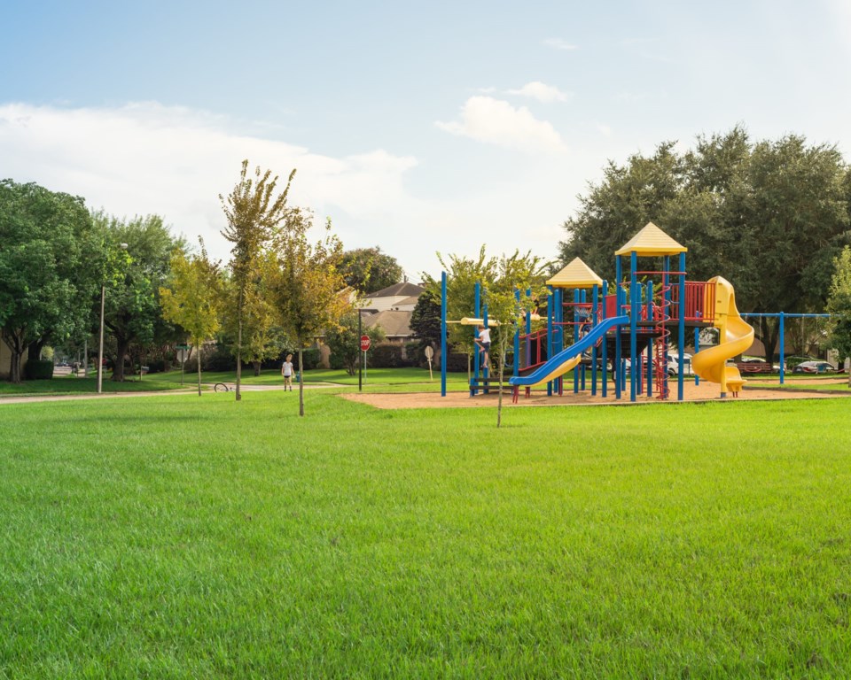 Colorful,Children,Playground,Activities,In,Public,Park,Surrounded,By,Green