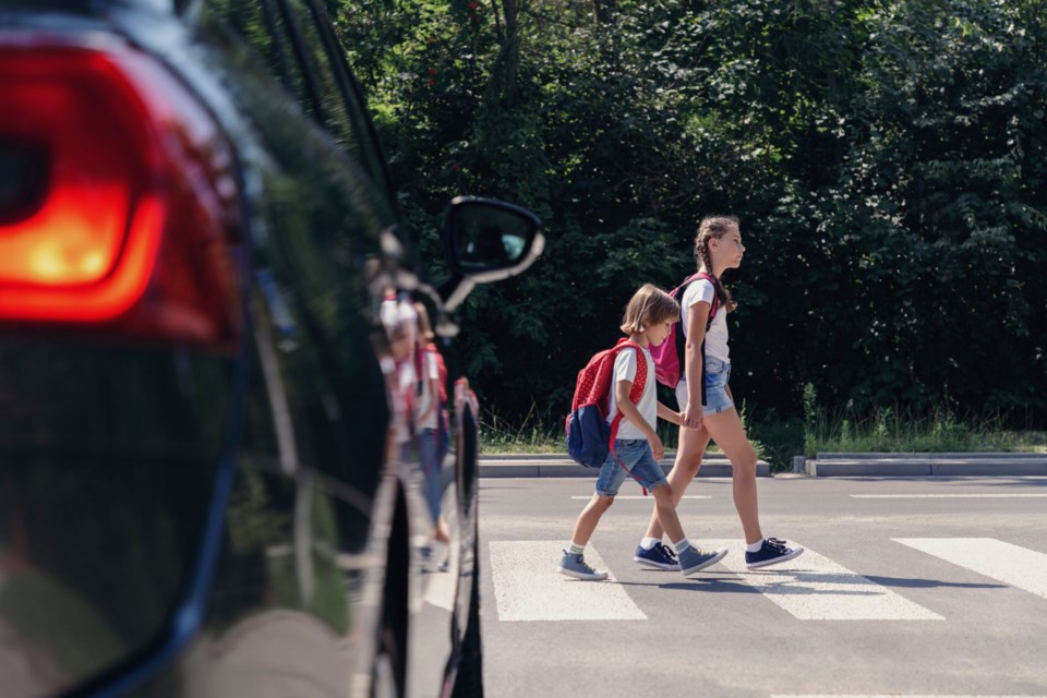 Children,Next,To,A,Car,Walking,Through,Pedestrian,Crossing,To