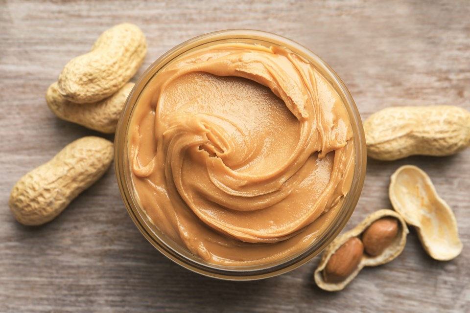 Glass,Bowl,With,Peanut,Butter,On,Wooden,Background