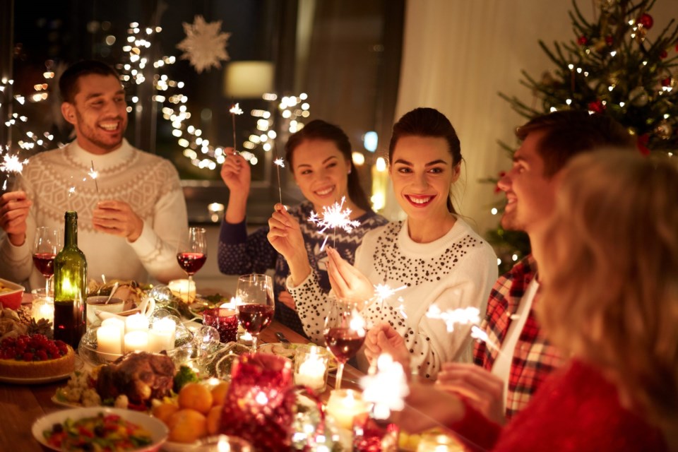 Winter,Holidays,And,People,Concept,-,Happy,Friends,With,Sparklers