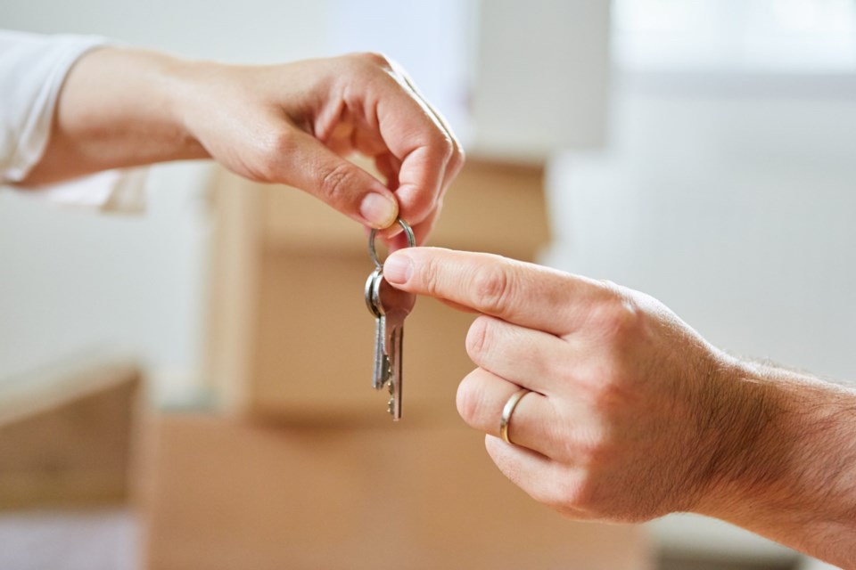 Two,Hands,Pass,A,House,Key,As,A,Symbol,Of