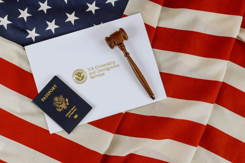 Us,Passports,With,Wooden,Judge,Gavel,On,American,Flag,On