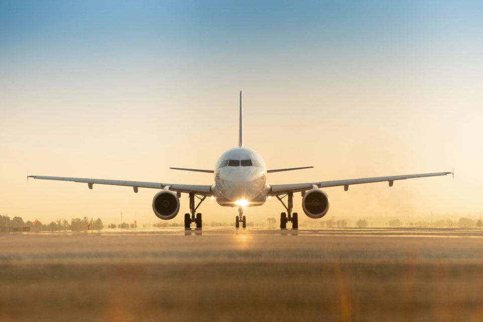 Sunset,View,Of,Airplane,On,Airport,Runway,Under,Dramatic,Sky