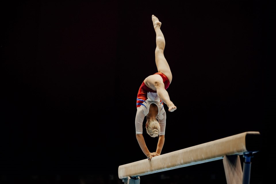 Balance,Beam,Handstand,Female,Gymnast,On,Black,Background