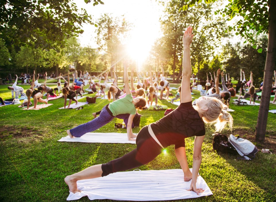 Big,Group,Of,Adults,Attending,A,Yoga,Class,Outside,In