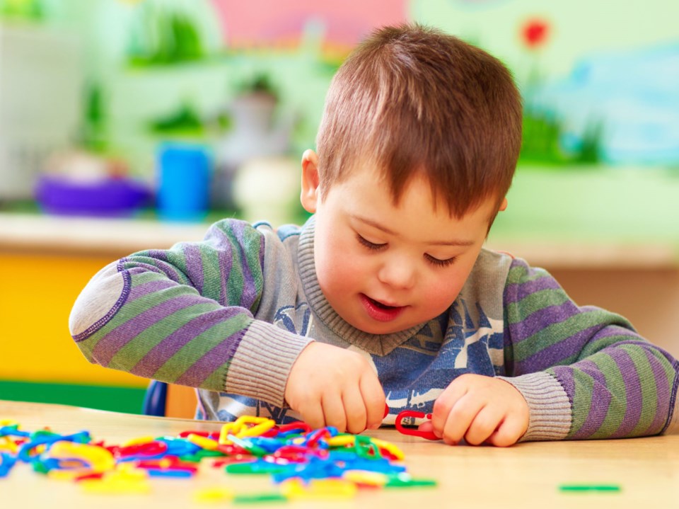 Cute,Kid,With,Down&#8217;s,Syndrome,Playing,In,Kindergarten