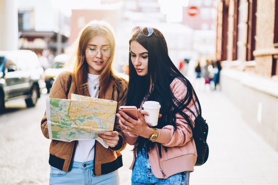 Hipster,Girls,In,Casual,Outfit,Looking,At,Map,And,Searching